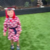 Boy jumping around in garden in spiderman robe